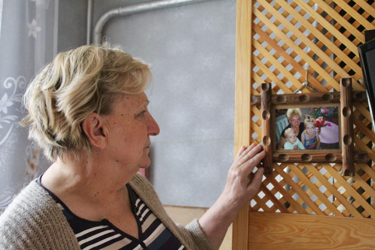 Tatjana aplūko savu mazbērnu fotogrāfijas.jpg